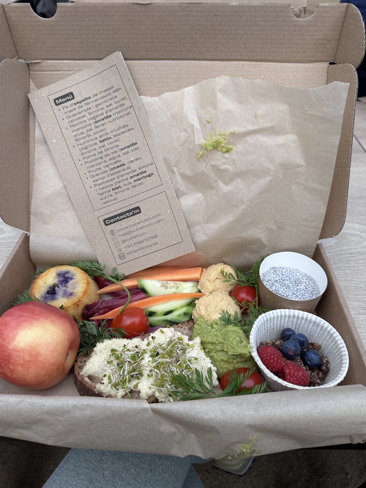 A curated take-away picnic box with fruit, cheese, and vegetables, ready for a day outdoors.